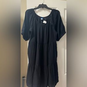 This is a black tiered mini swing dress in a size large